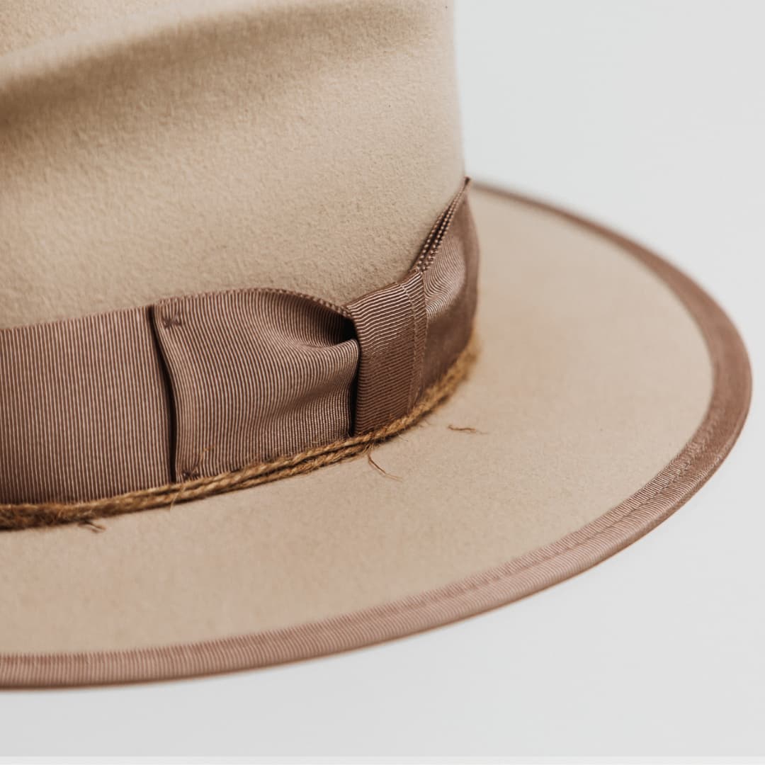 Close up detail of the Plaster felt hat showing plaster grosgrain brim trim and twine wrapping.
