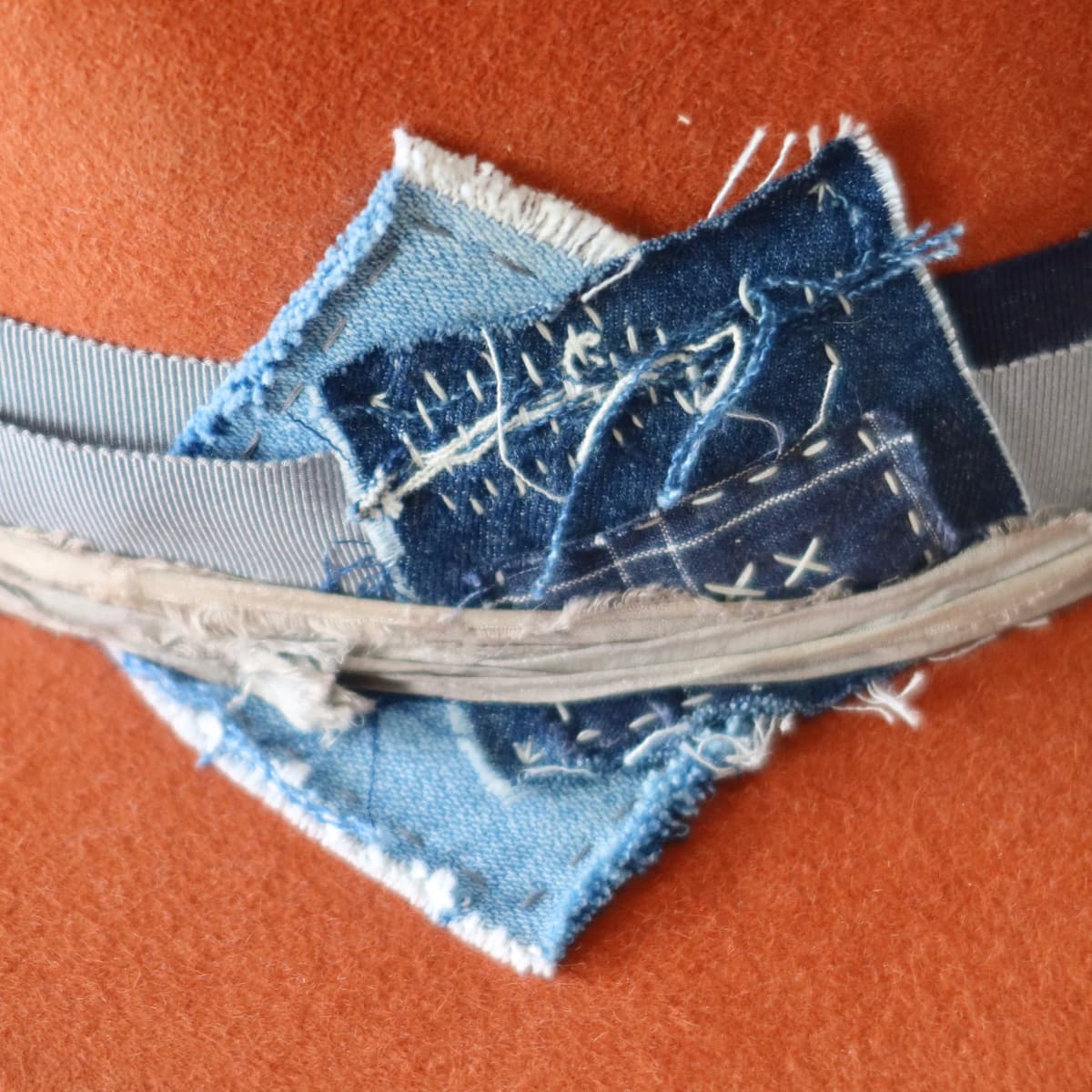 Close up detail of the Road Less Travelled felt hat showing layered denim patchwork with sashiko style stitching.