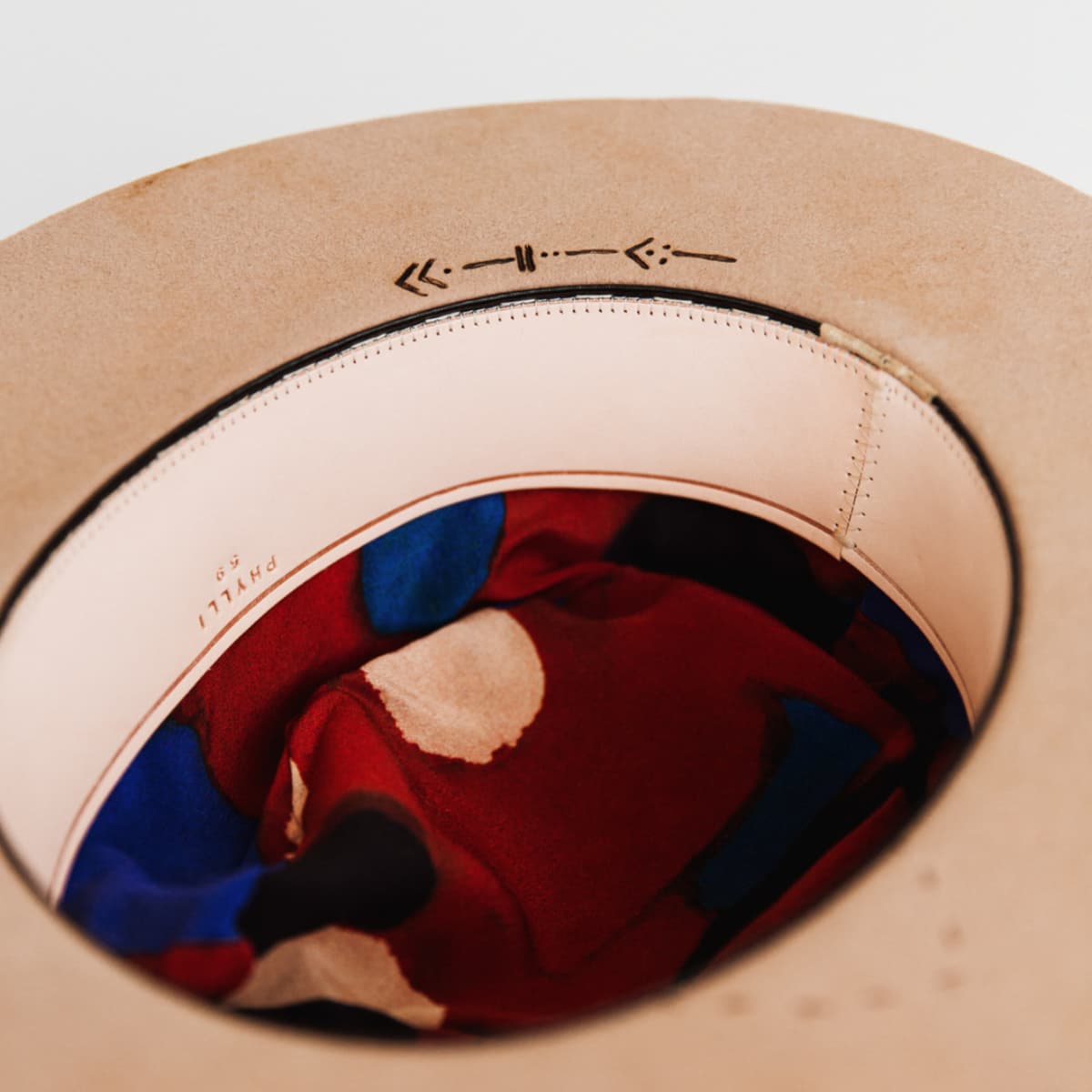 Interior view of Roadie felt hat by PHYLLi Designs showing leather sweatband and silk lining.
