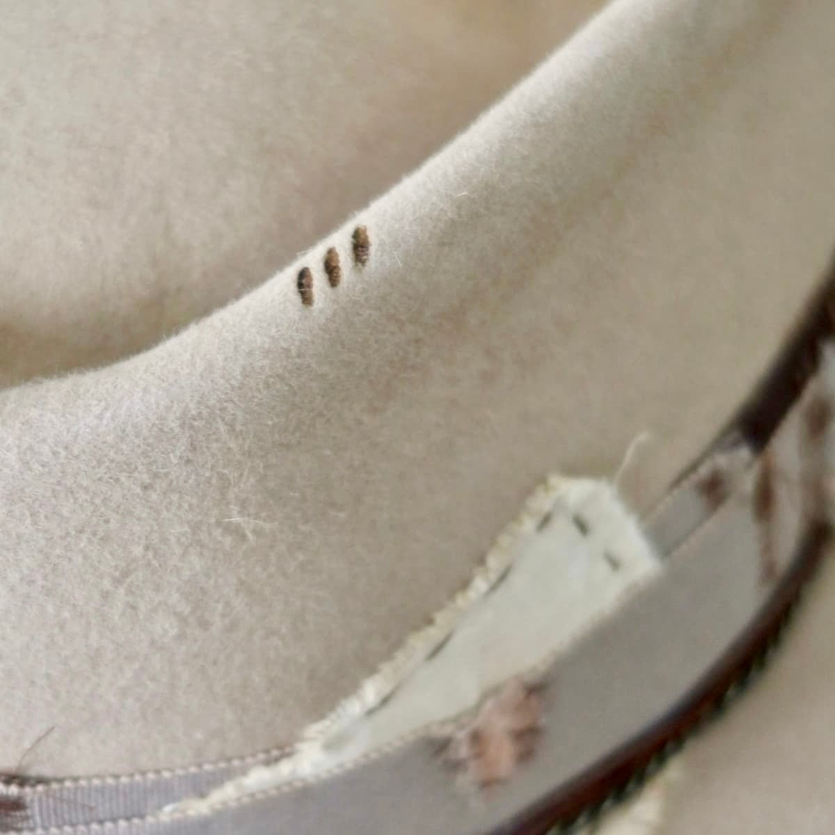 Close up of Roadie felt hat by PHYLLi Designs showing burnt branded detail.