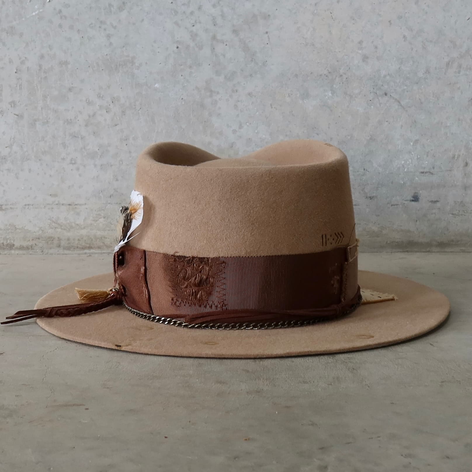 Back view of Roadie felt hat by PHYLLi Designs with distressed grosgrain band and crown chain.
