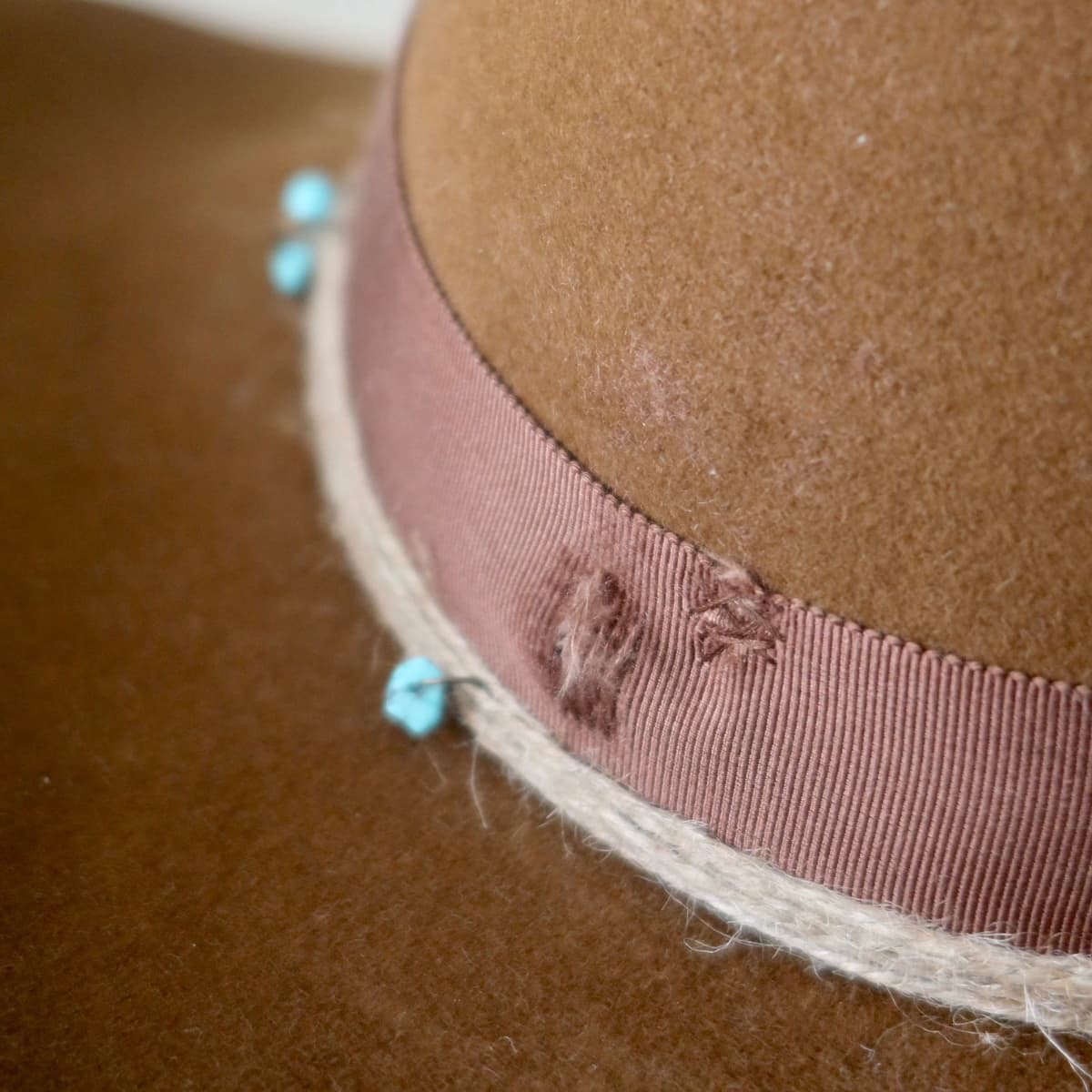 Close up detail of the Rue cowboy hat showing distressed chocolate Japanese grosgrain band.