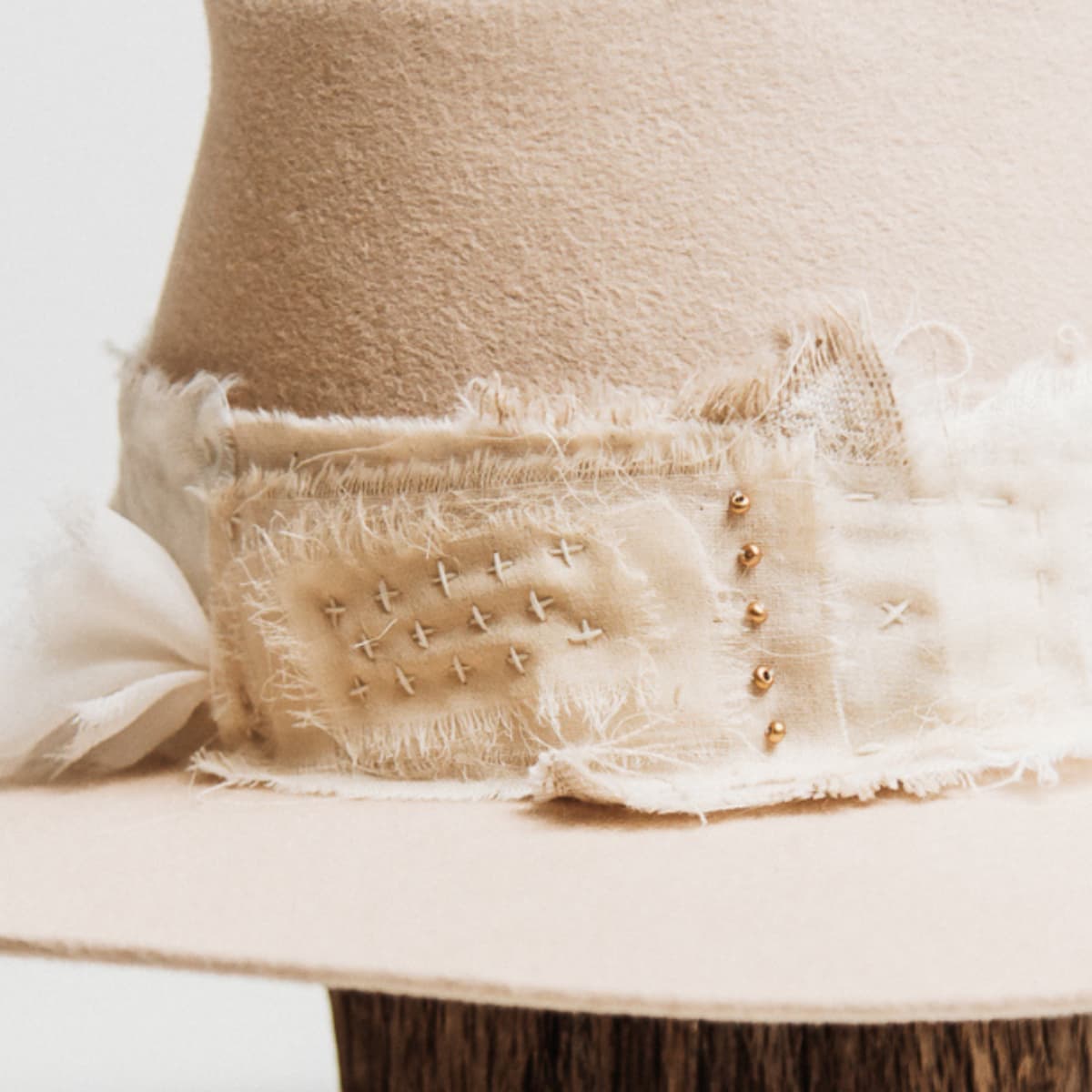 Close up detail of the Sabi Limited Edition felt hat showing matte gold bead accents scattered across the Wabi Sabi patch band.