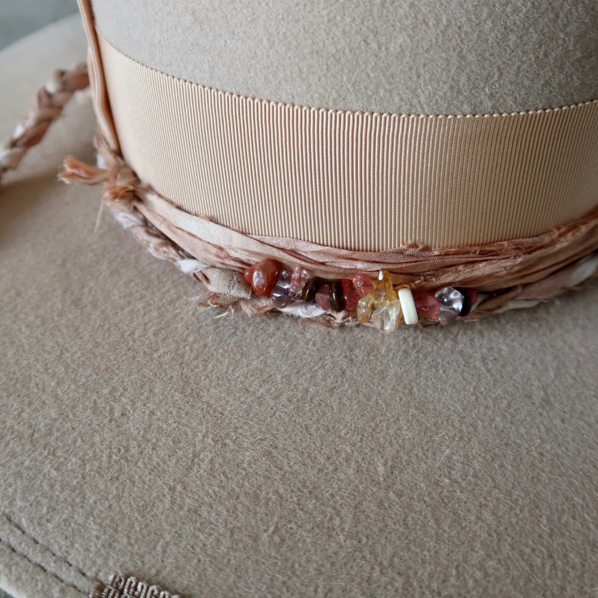 Close up detail of the Sandstone Limited Edition felt hat showing crystal cluster with assorted beading and quartz crystals.