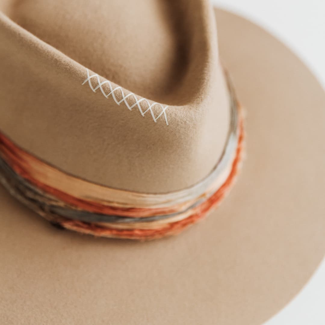 Close up detail of hand-stitched crosses in Ivory on Santa Fe Autumn premium felt hat in Sahara.