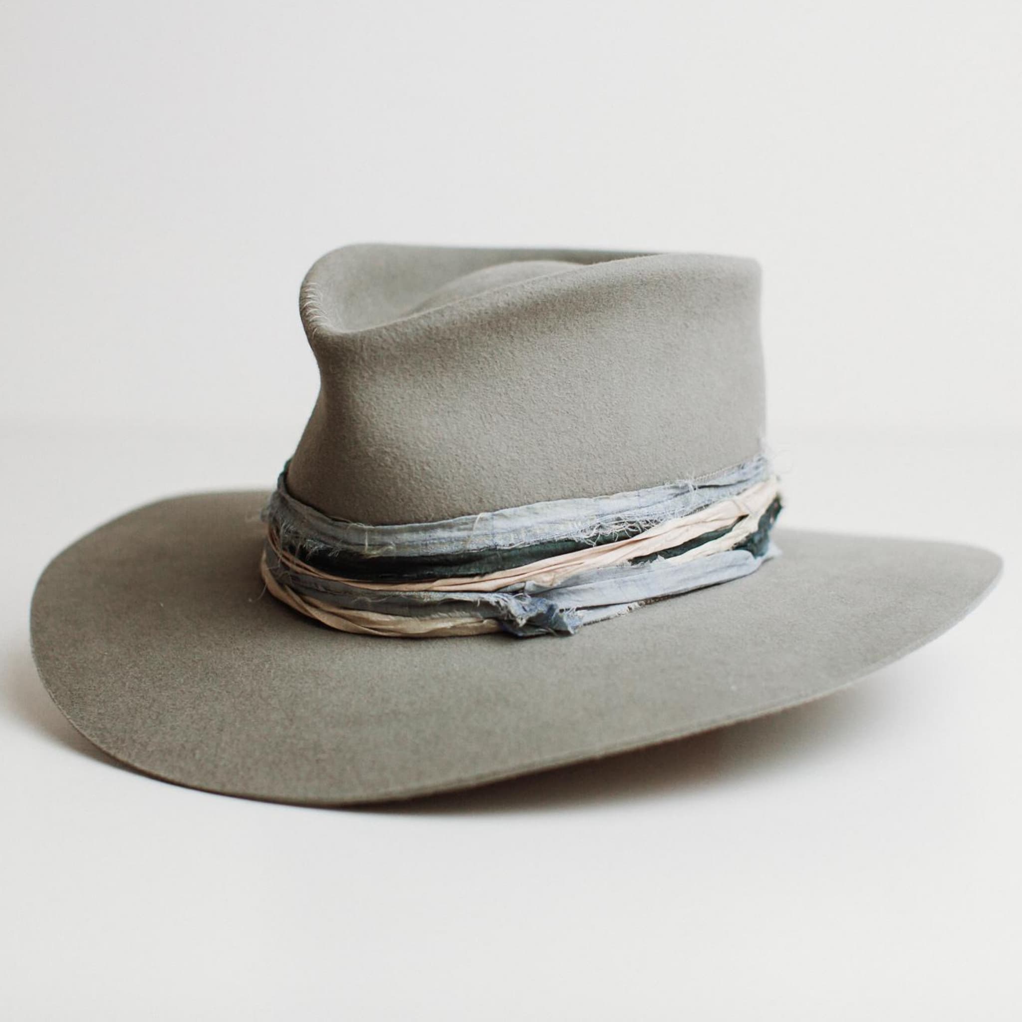 Front left angle of Santa Fe Winter felt hat by PHYLLi Designs with cement grosgrain band and sari silk trimming.