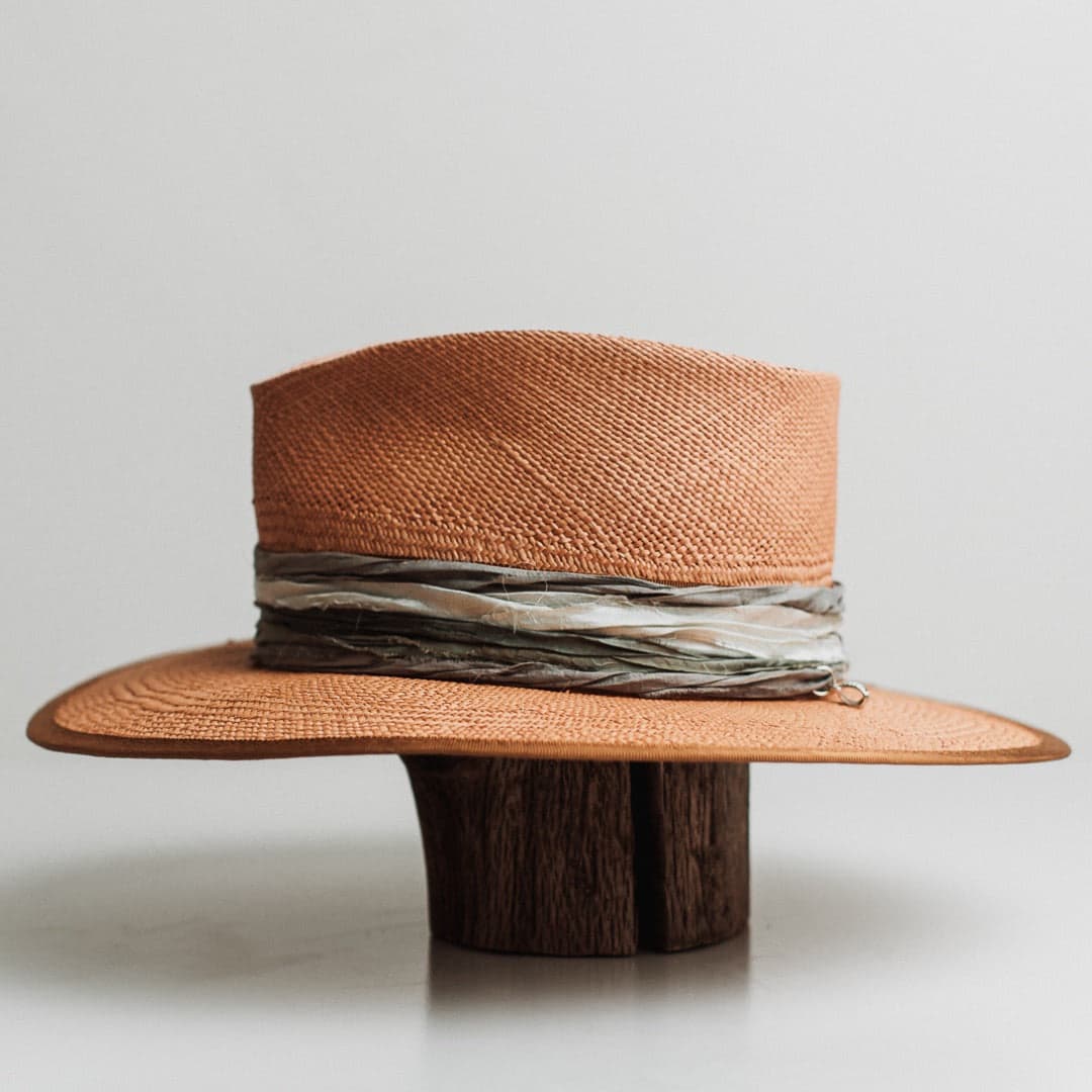 Left side view of the Santa Fe Winter Panama biscuit Panama hat by PHYLLi Designs with copper grosgrain brim trim and sari silk wrap in teal and storm blue.