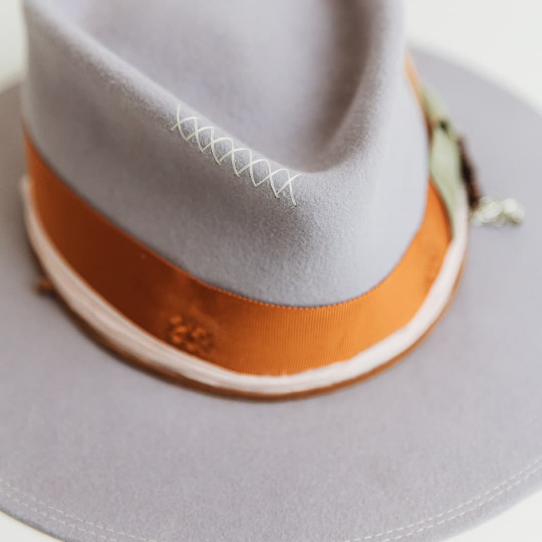 Close up detail of Santa Monica Lilac felt hat by PHYLLi Designs featuring hand-stitched crosses in ivory.