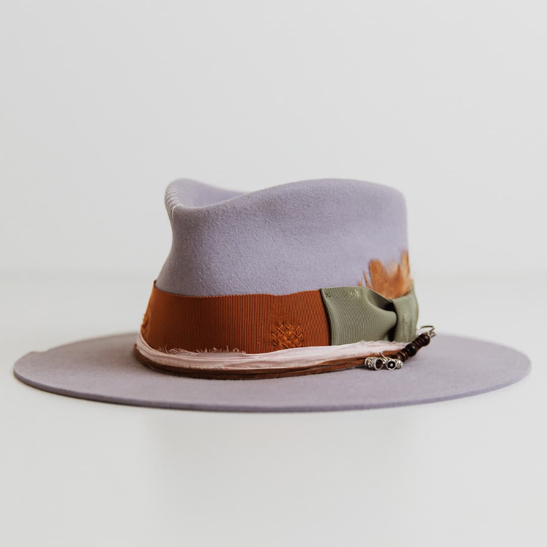 Front left angle of Santa Monica Lilac felt hat by PHYLLi Designs with rust grosgrain band, oil green bow and sari silk trim.