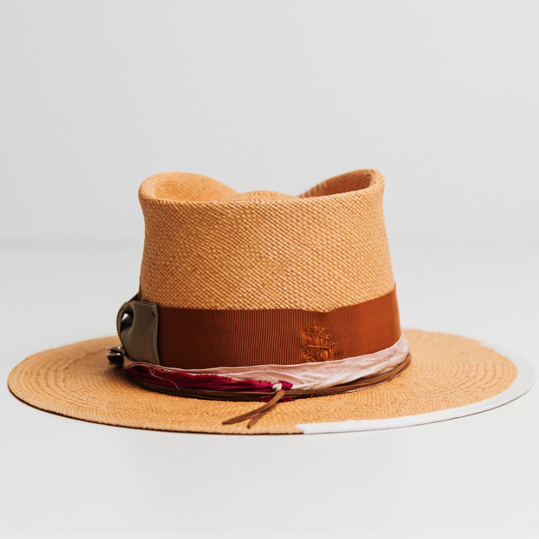 Side view of Santa Monica Panama hat with rust distressed grosgrain band and rose sari silk trim.