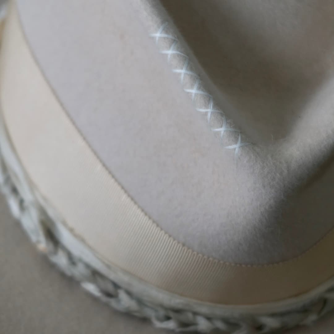 Close up detail of the Shoalhaven felt hat showing the ivory cross stitching on the crown.