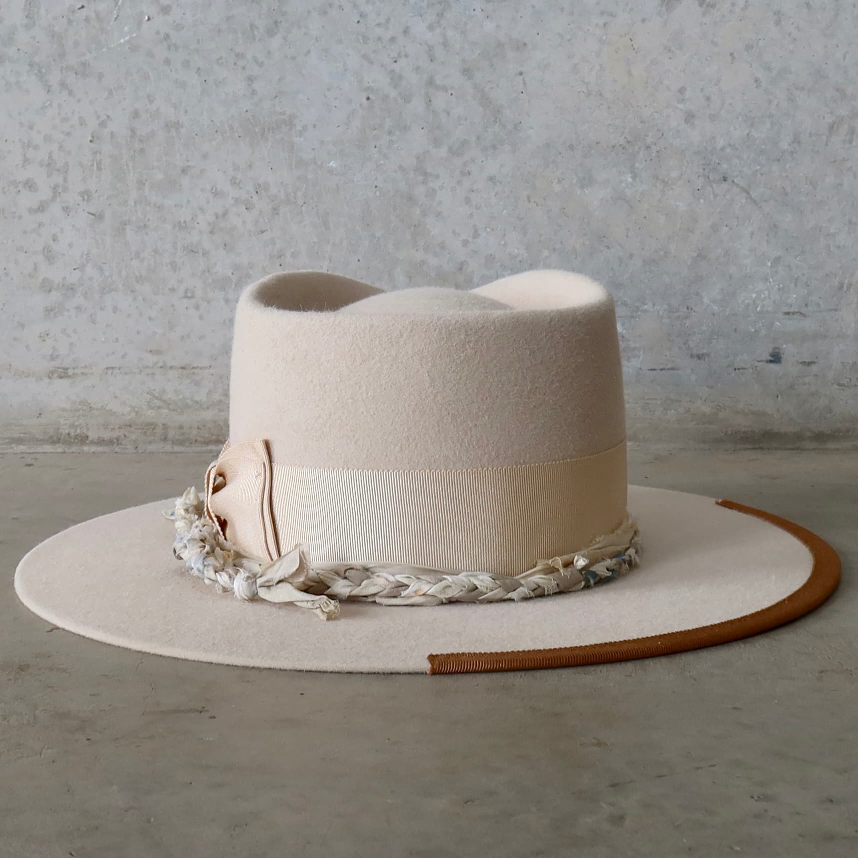 Back view of the beige felt hat Shoalhaven by PHYLLi Designs featuring copper grosgrain 1/3 brim trim.