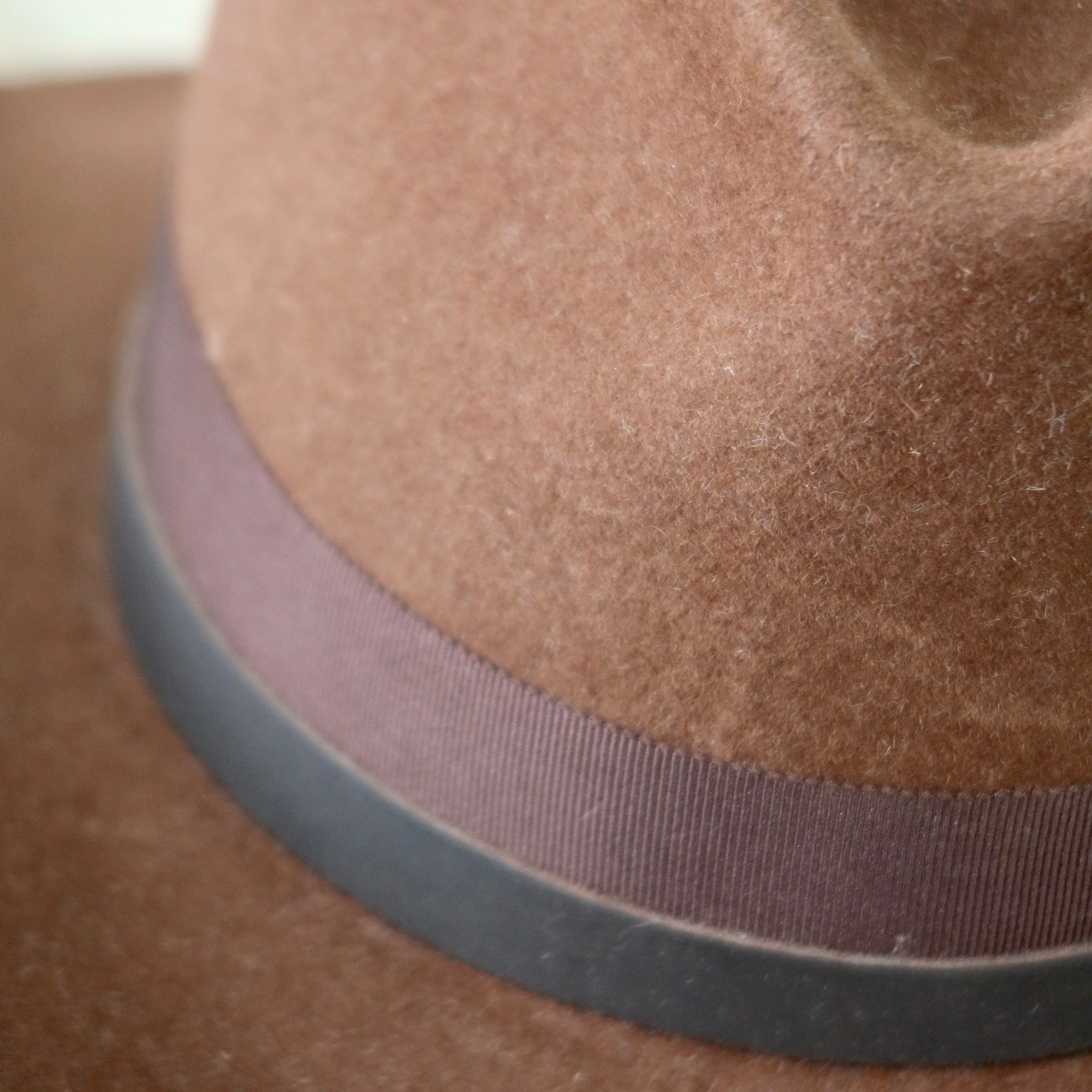 Close up detail of the Spicer cowboy hat showing chocolate grosgrain band and leather tie back trim.