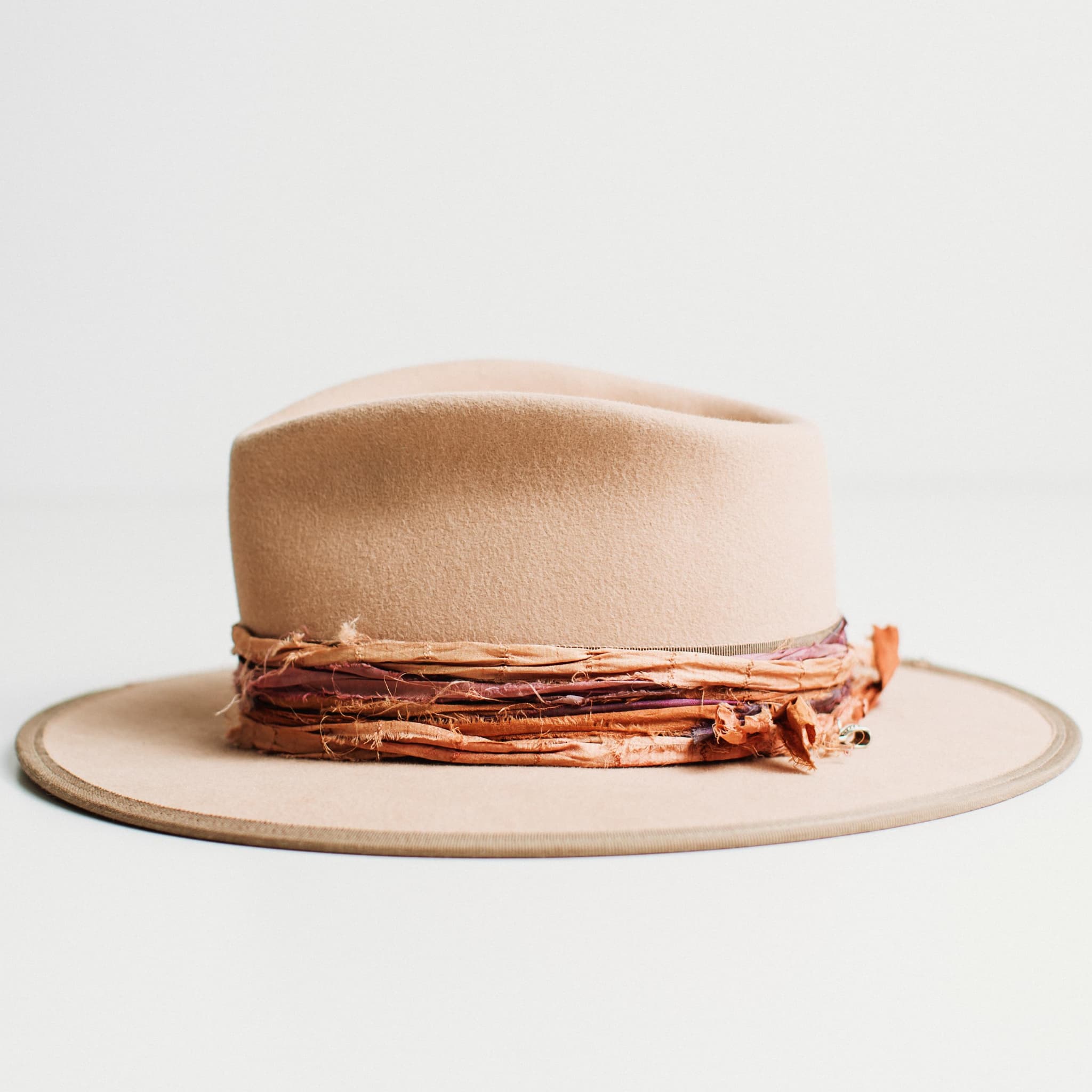 Left side view of sand felt hat with vintage French grosgrain band and sunset sari silk trim by PHYLLi Designs.