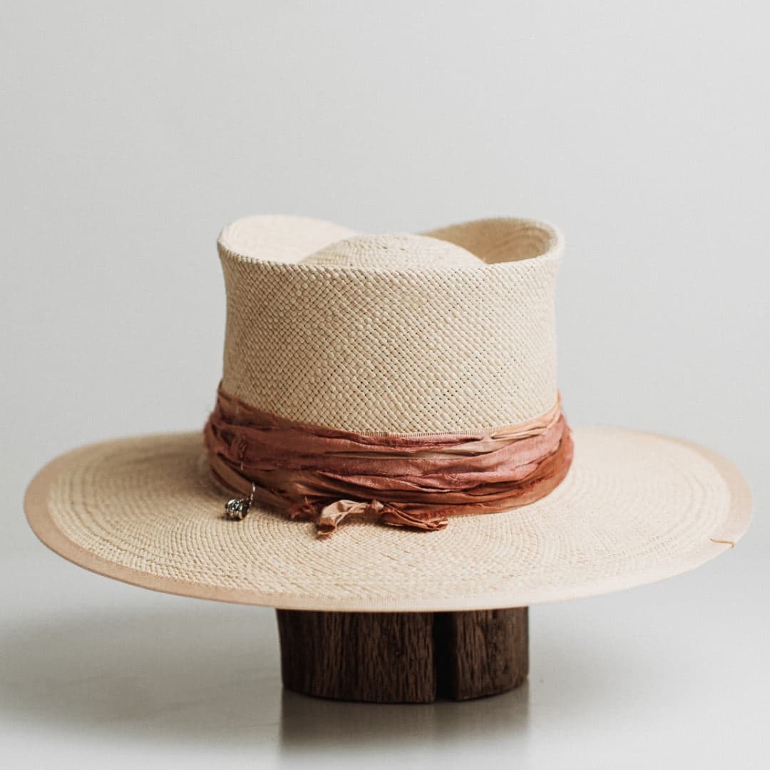 Back view of the Sunset Panama natural Panama hat by PHYLLi Designs featuring layered sari silk trimming in apricot, dusty pink and rust.