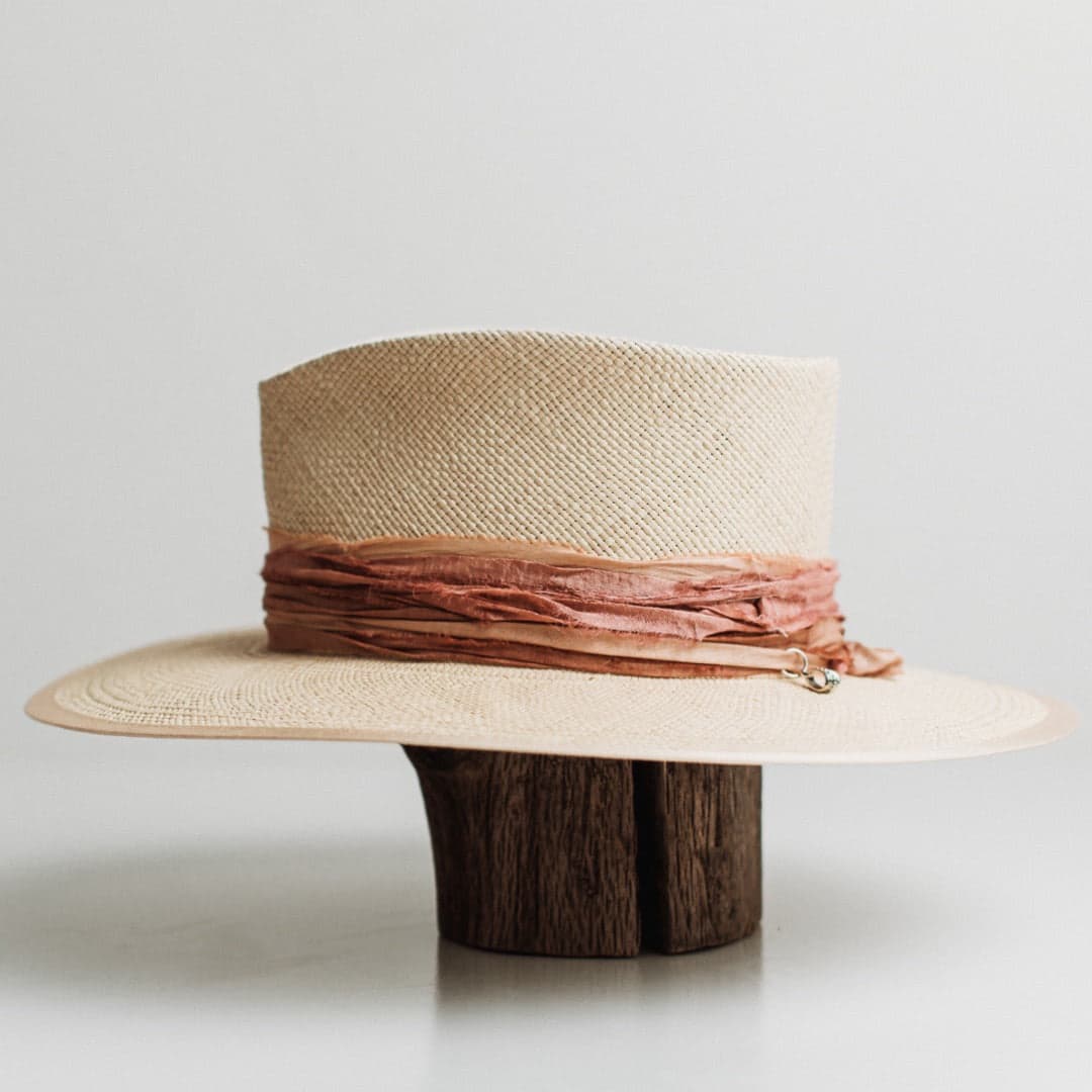 Left side view of the Sunset Panama natural Panama hat by PHYLLi Designs with sand grosgrain brim trim and apricot sari silk wrap.