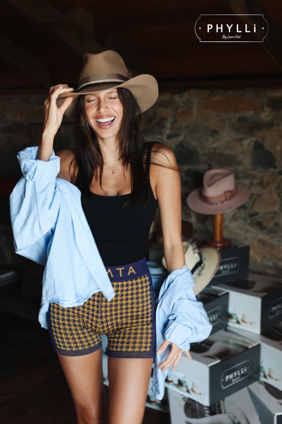 Woman wearing a PHYLLi Designs western felt hat during the TCMF Wheeler hat bar event.