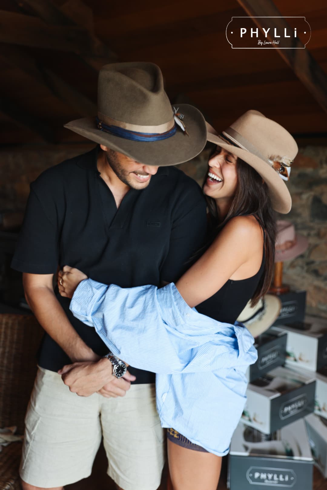 Couple wearing handcrafted western felt hats by PHYLLi Designs during the TCMF Wheeler hat bar.