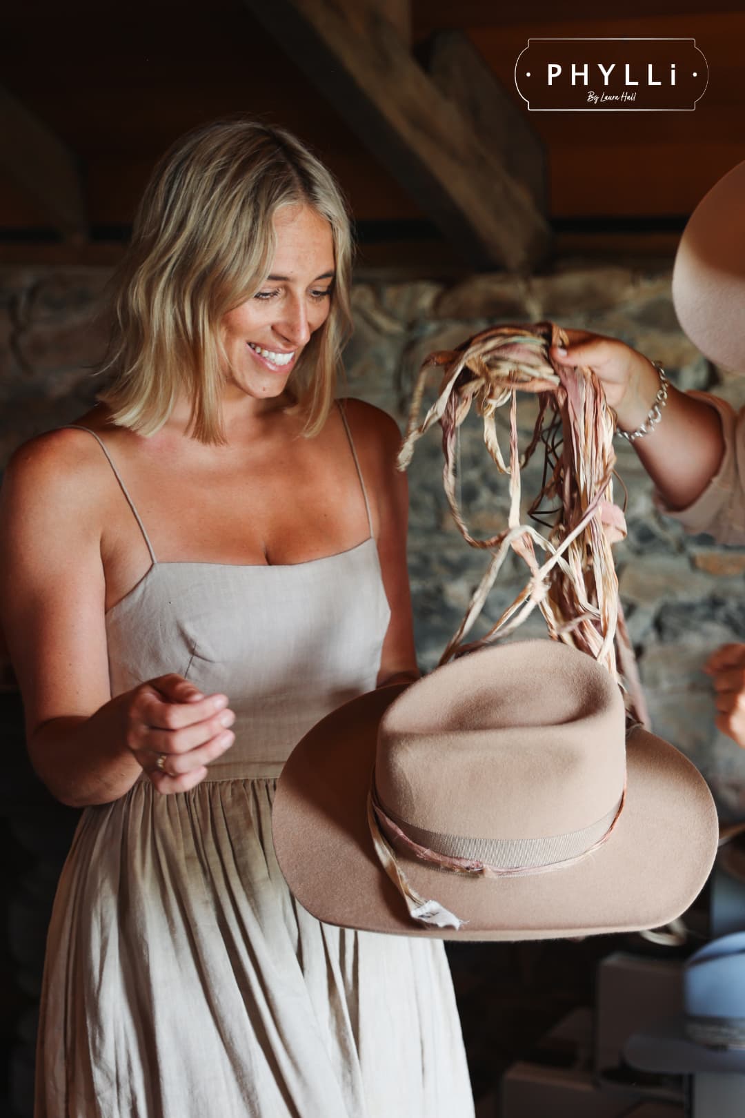 Guest selecting sari silk trims for a handcrafted felt hat during the PHYLLi Designs TCMF Wheeler hat bar.