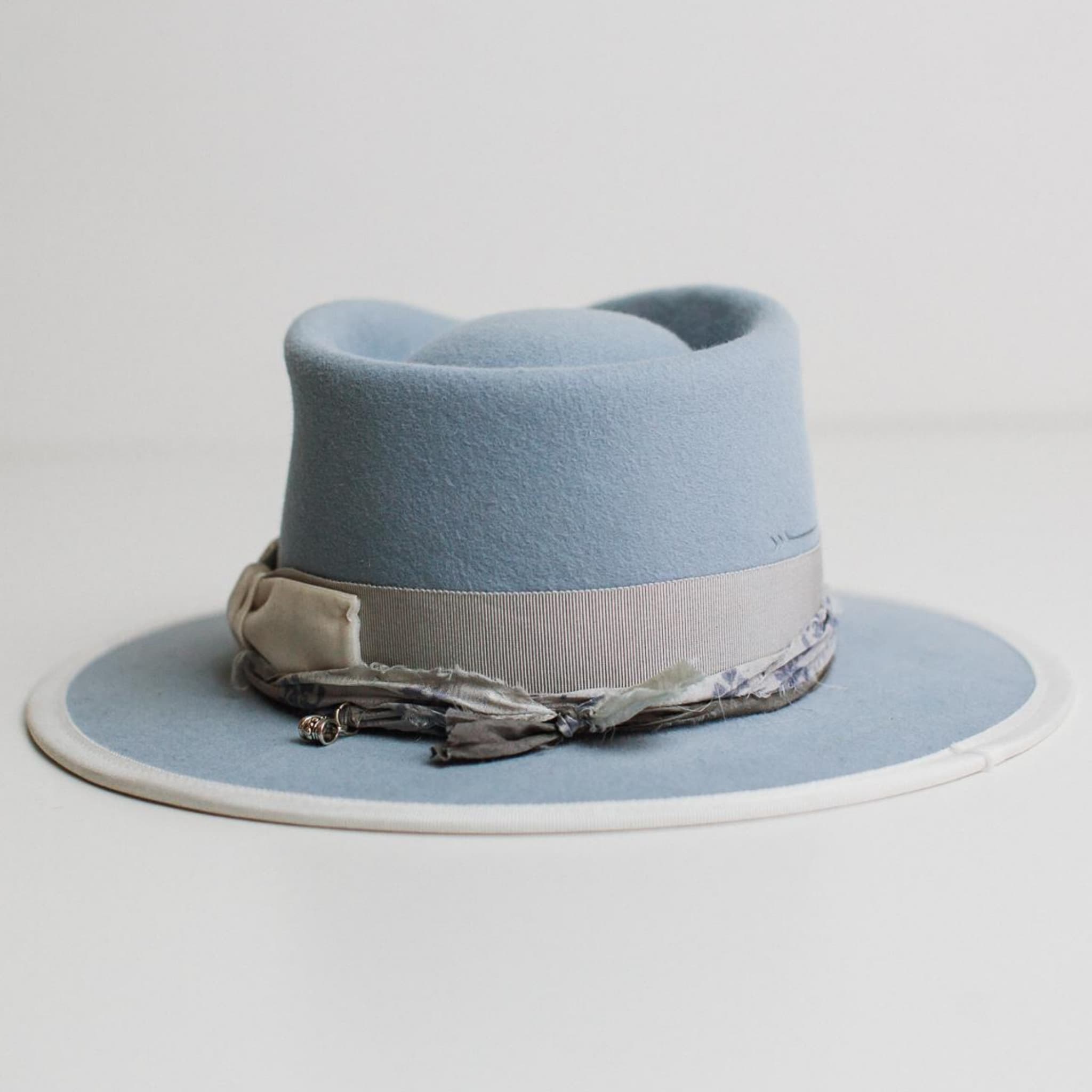 Back view of The Arrow crystal blue felt hat by PHYLLi Designs featuring hand-stitched arrow detail in crystal blue.
