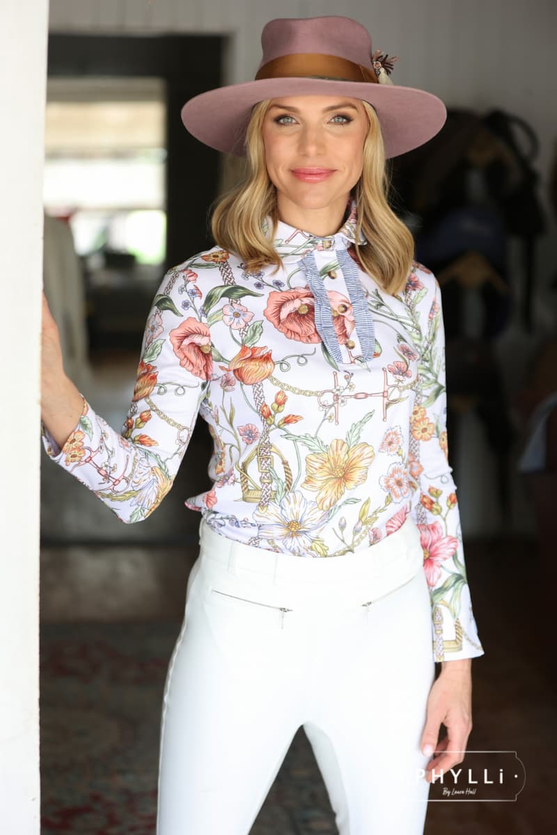 Woman in equestrian outfit wearing The Blush pink felt hat with copper grosgrain band.