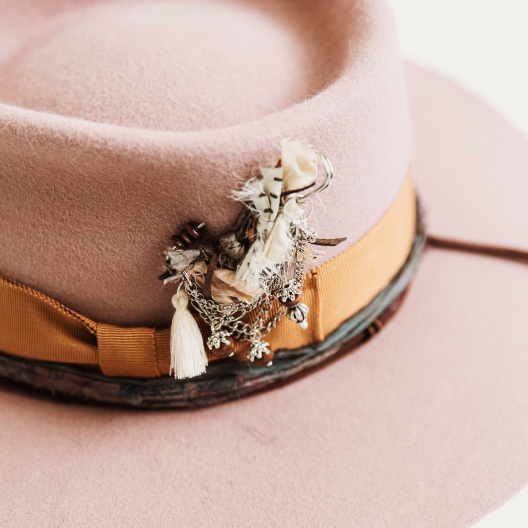 Close up of eggplant sari silk trim and suede string on The Blush felt hat by PHYLLi Designs.