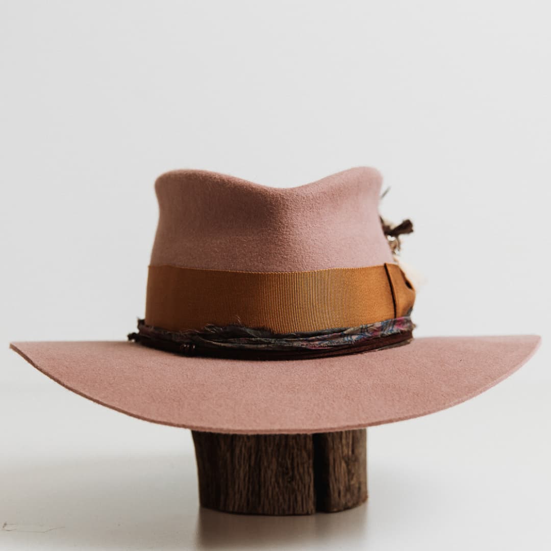 Front view of The Blush felt hat by PHYLLi Designs in blush with copper grosgrain band and sari silk trim.