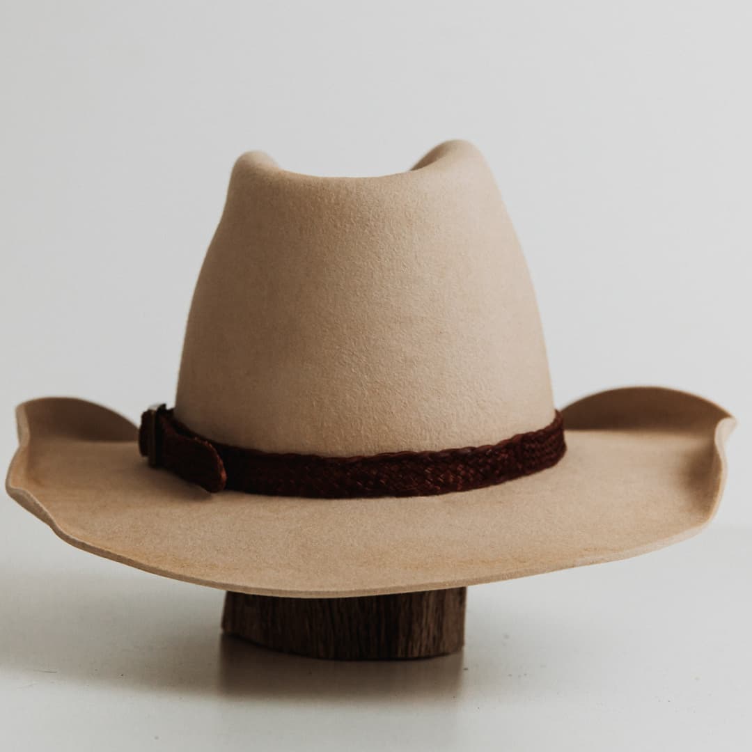 Back view of The Contractor premium felt hat in Beige with 12 strand plaited leather hat band in Chocolate featuring bronze buckle.