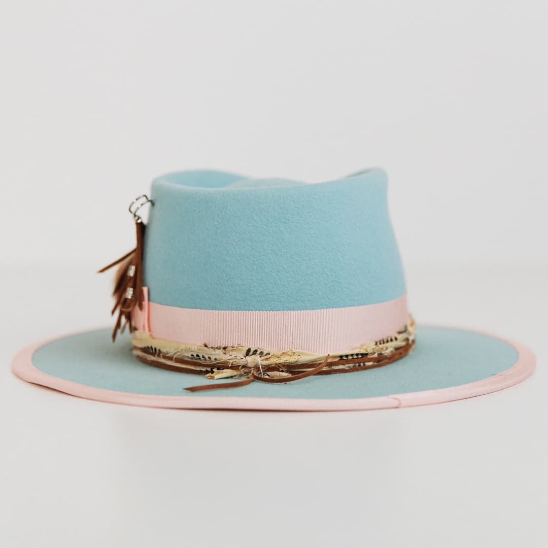 Back view of The Cyan felt hat by PHYLLi Designs with sherbet pink grosgrain band and sari silk trim.