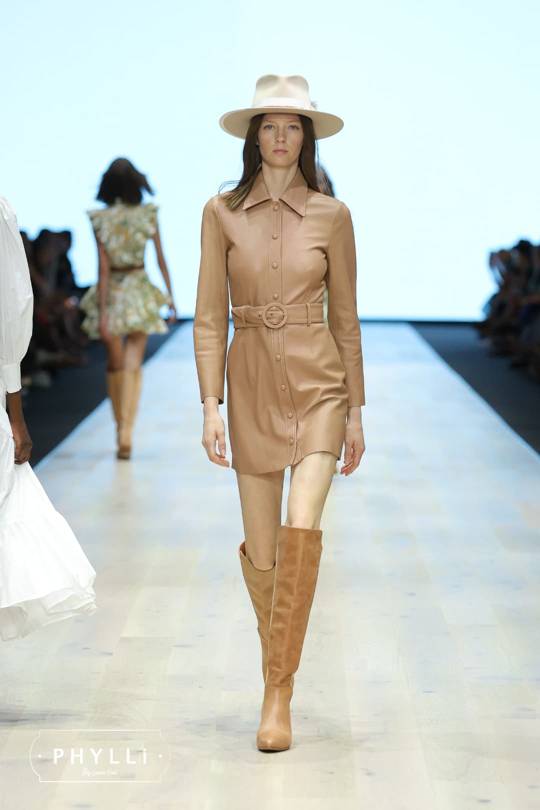 Runway model wearing The Dartbrook beige felt hat by PHYLLi Designs during fashion show.