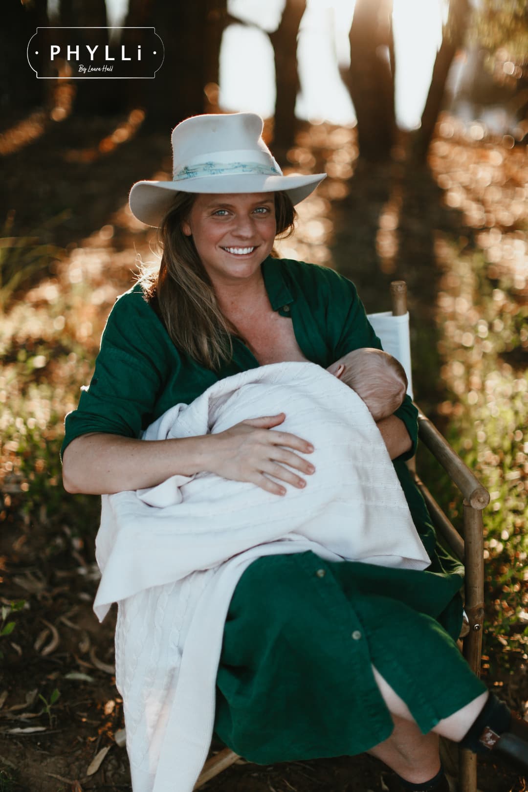 Portrait of woman wearing The Dove felt hat by PHYLLi Designs in golden hour bush setting.