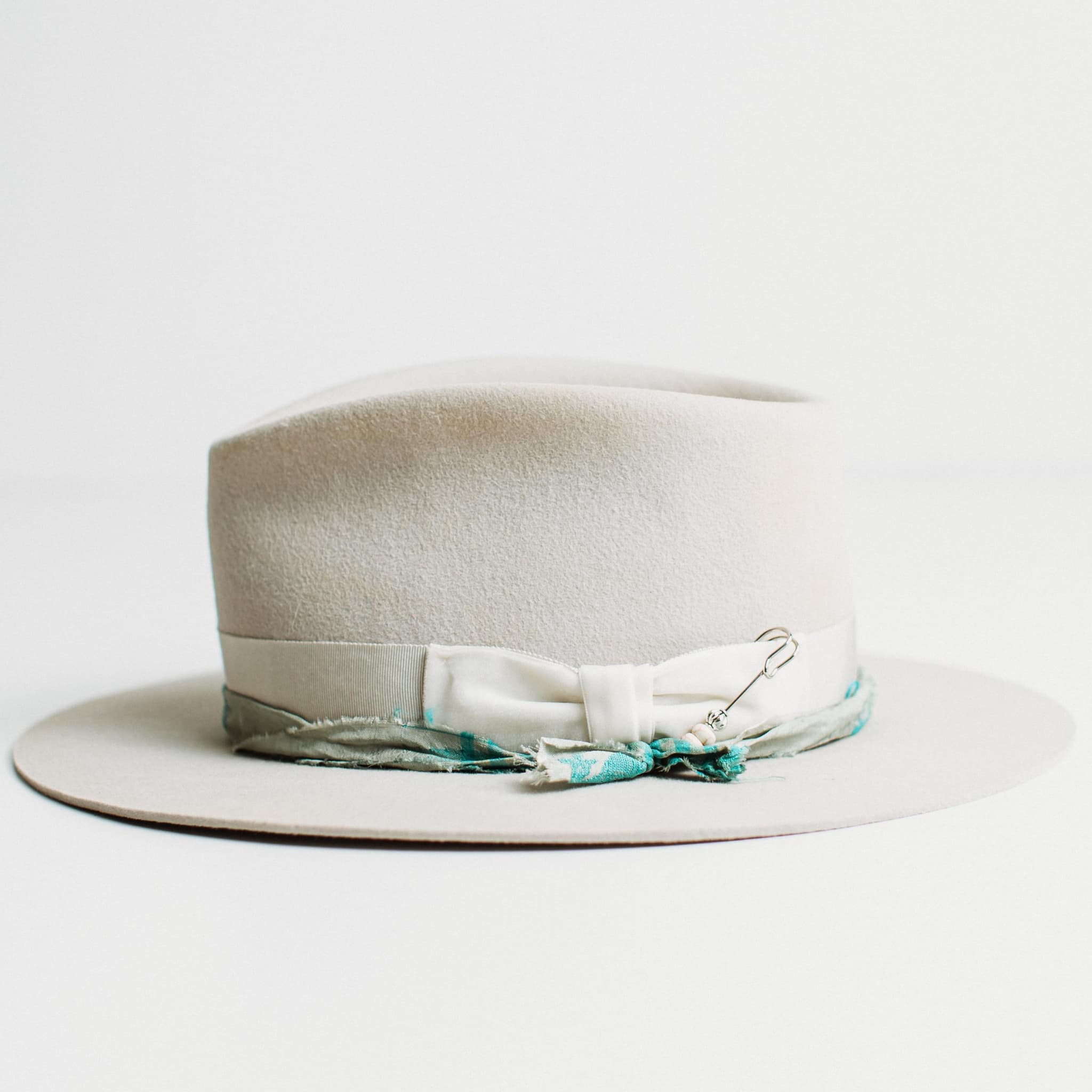 Left side view of dove felt hat with Japanese grosgrain band and sari silk trim by PHYLLi Designs.