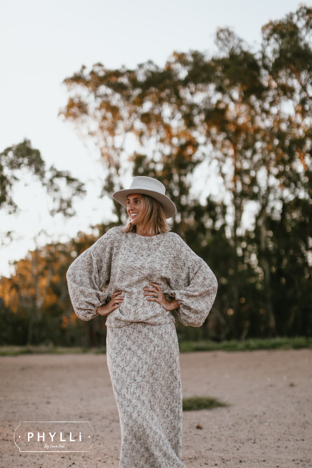 Grace Brennan wearing The Dove felt hat by PHYLLi Designs outdoors in natural bush setting.
