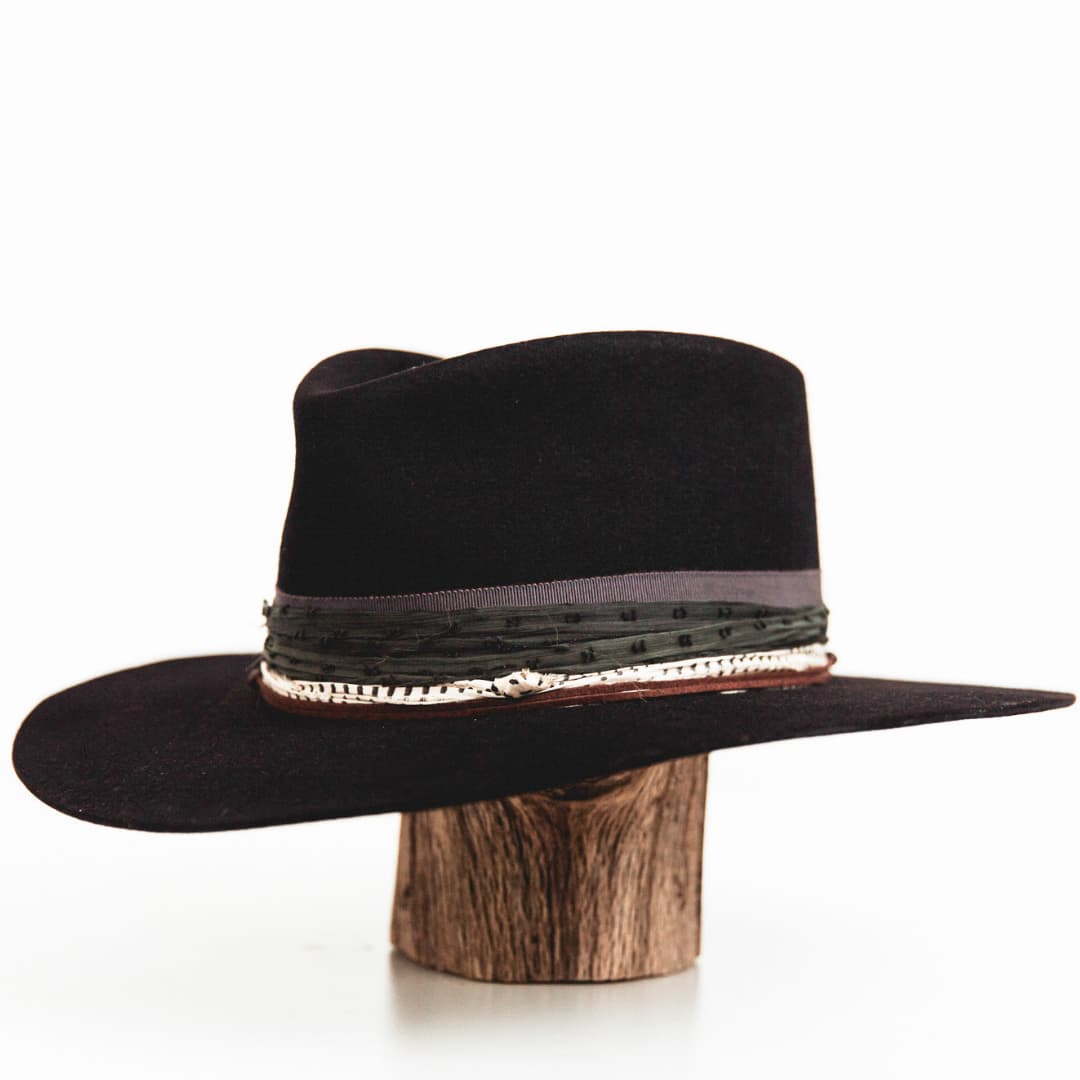 Front left angle of The Ellerston dark navy rabbit felt hat featuring slate grosgrain band and sari silk trim.