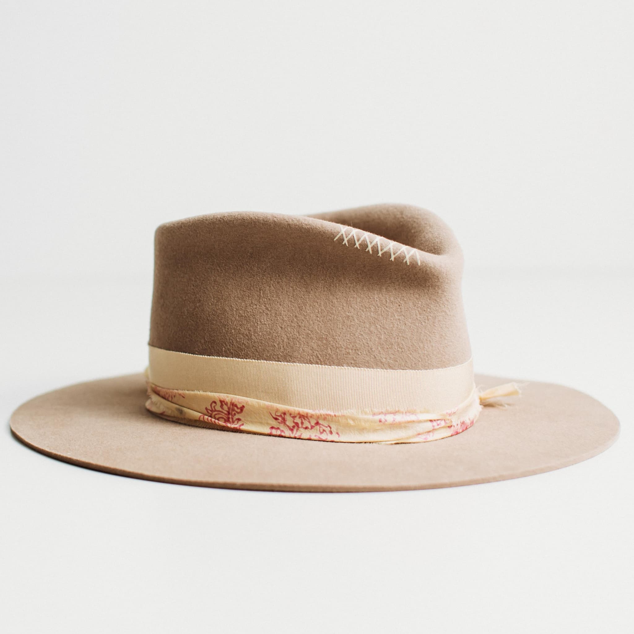 Front right angled view of The Fawn sahara felt hat with grosgrain bow band and patterned sari silk trim by PHYLLi Designs.