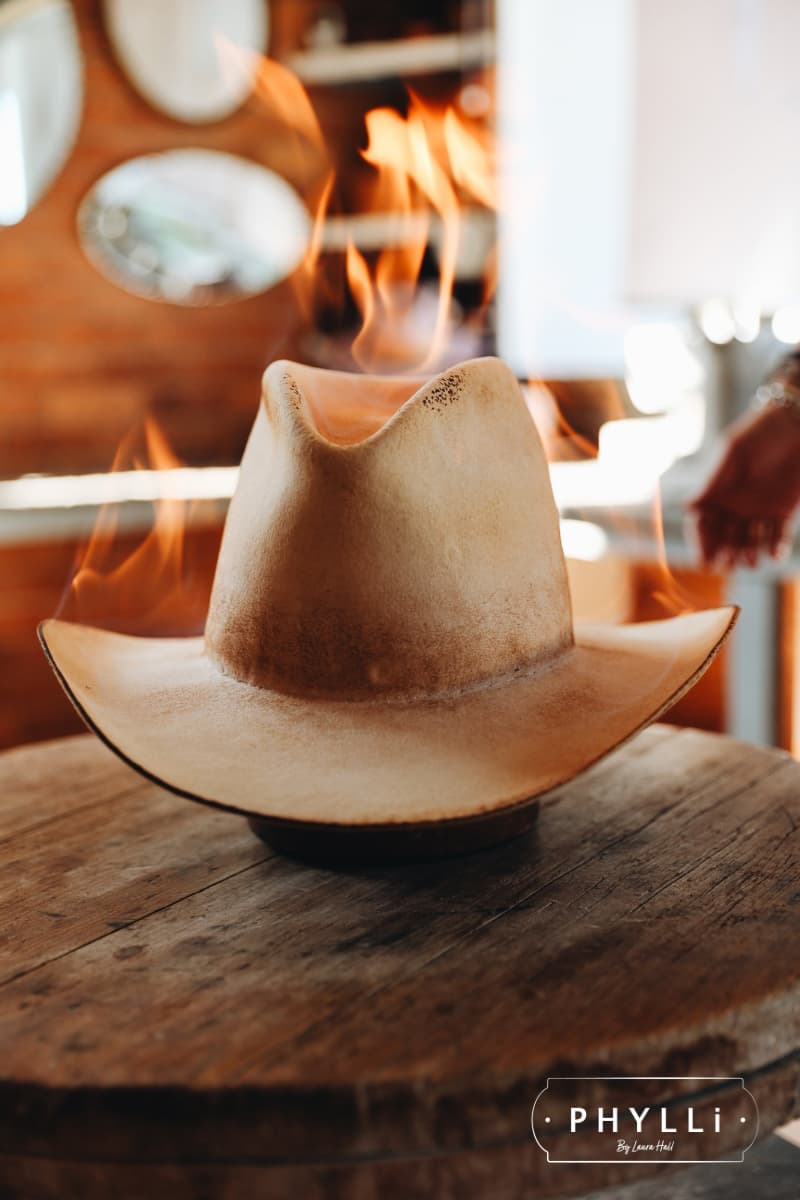 Western weight rabbit felt hat being distressed by flame during the PHYLLi hat making process.