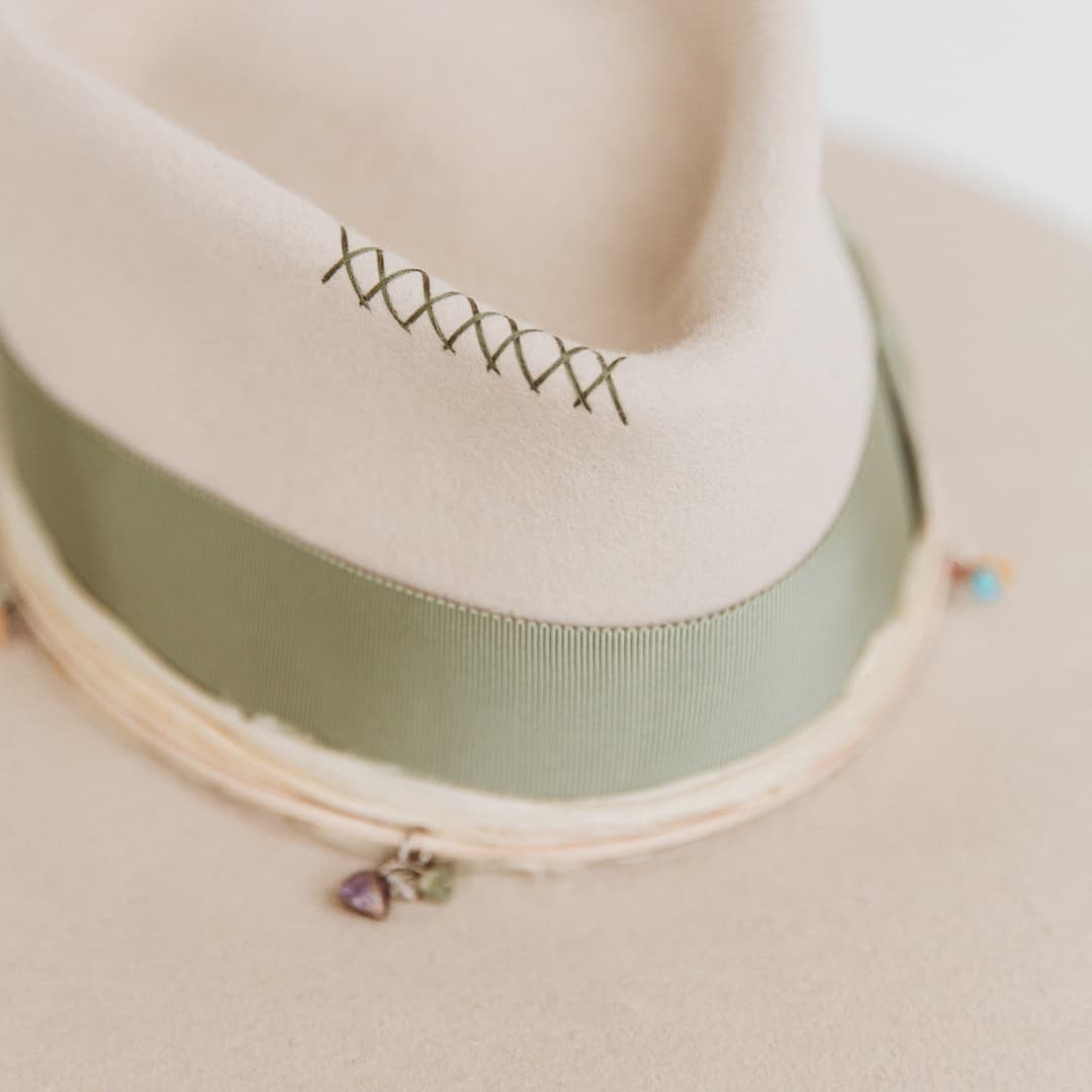 Close up of hand-stitched crosses and sari silk trim on The Guardian felt hat by PHYLLi Designs.