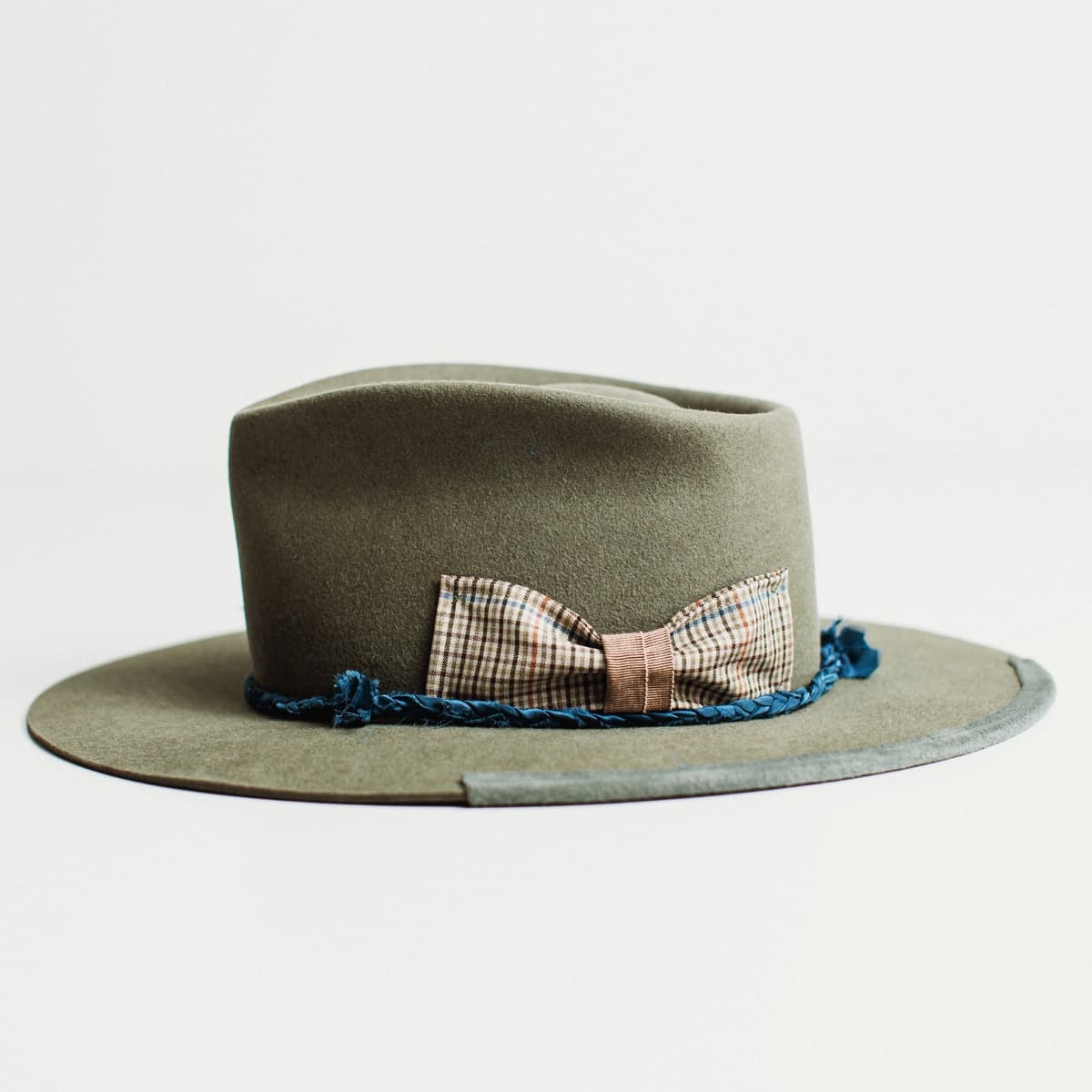Left side view of military felt hat with silk plait band and floating bow detail by PHYLLi Designs.