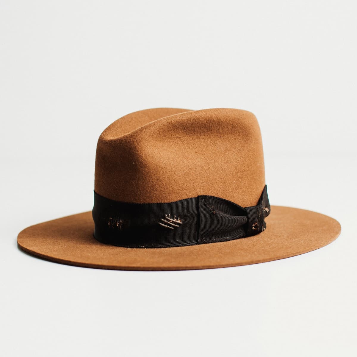 Front left angled view of The Open Road caramel felt hat with Open Road cowboy crown and black grosgrain band.