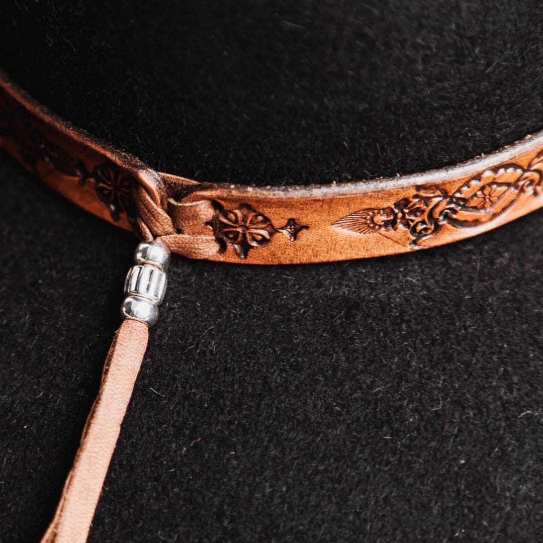 Close up detail of The PHYLLi felt hat showing leather tie back cord with silver bead.