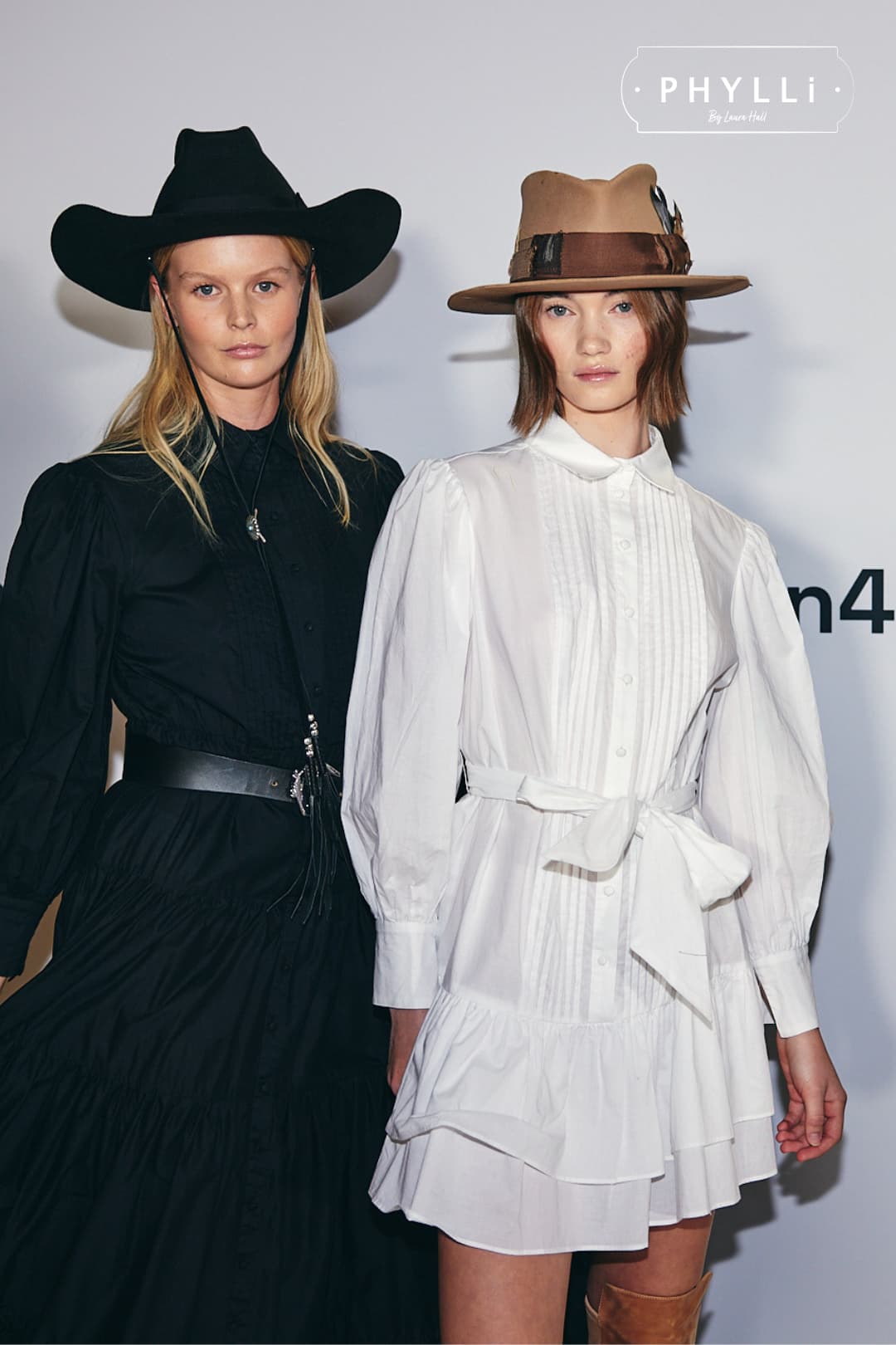 Runway models backstage wearing PHYLLi Designs felt hats including The Plains black cowboy hat with grosgrain bow band.