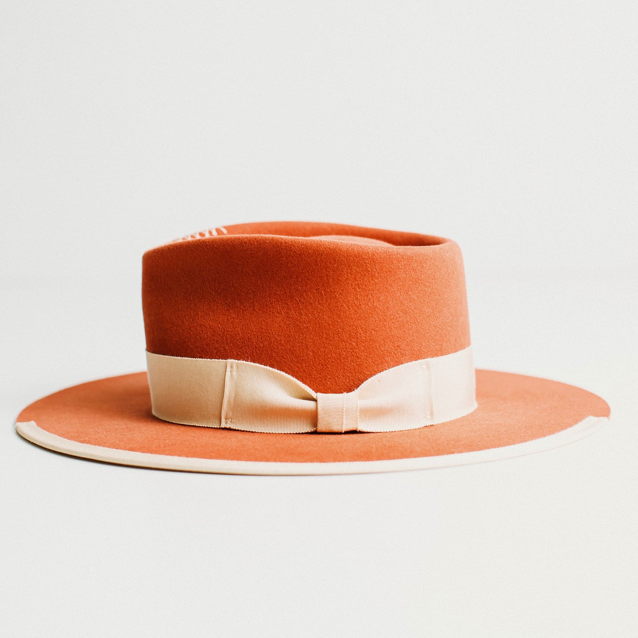 Side view of the Producer felt hat in spiced pumpkin with sand band by PHYLLi Designs.