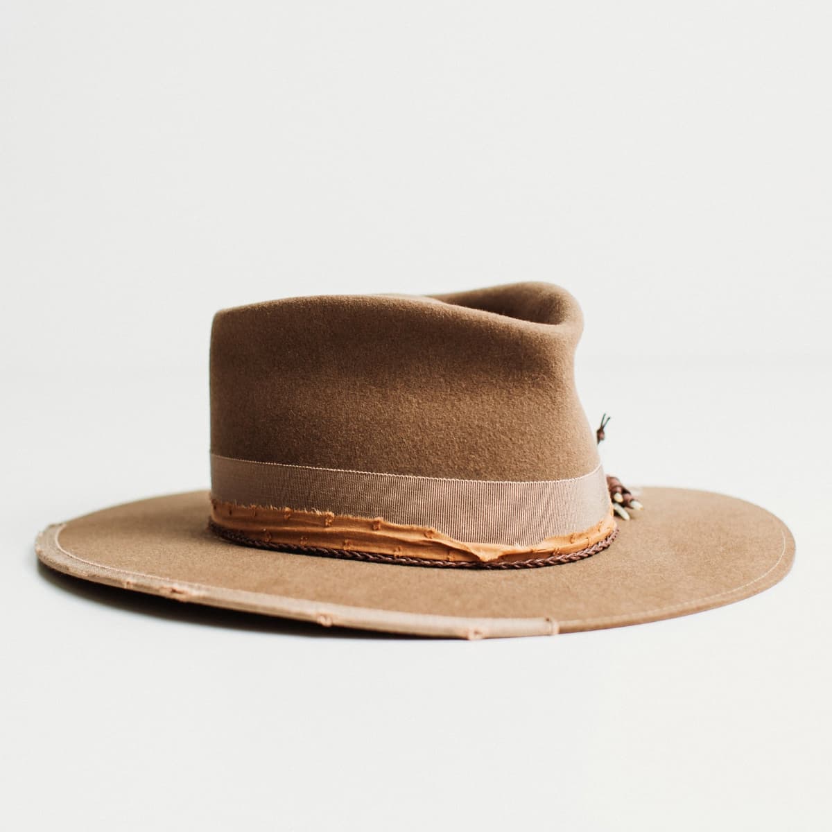Front right angled view of The Rider havana brown felt hat with vintage grosgrain bow band and distressed brim trim by PHYLLi Designs.