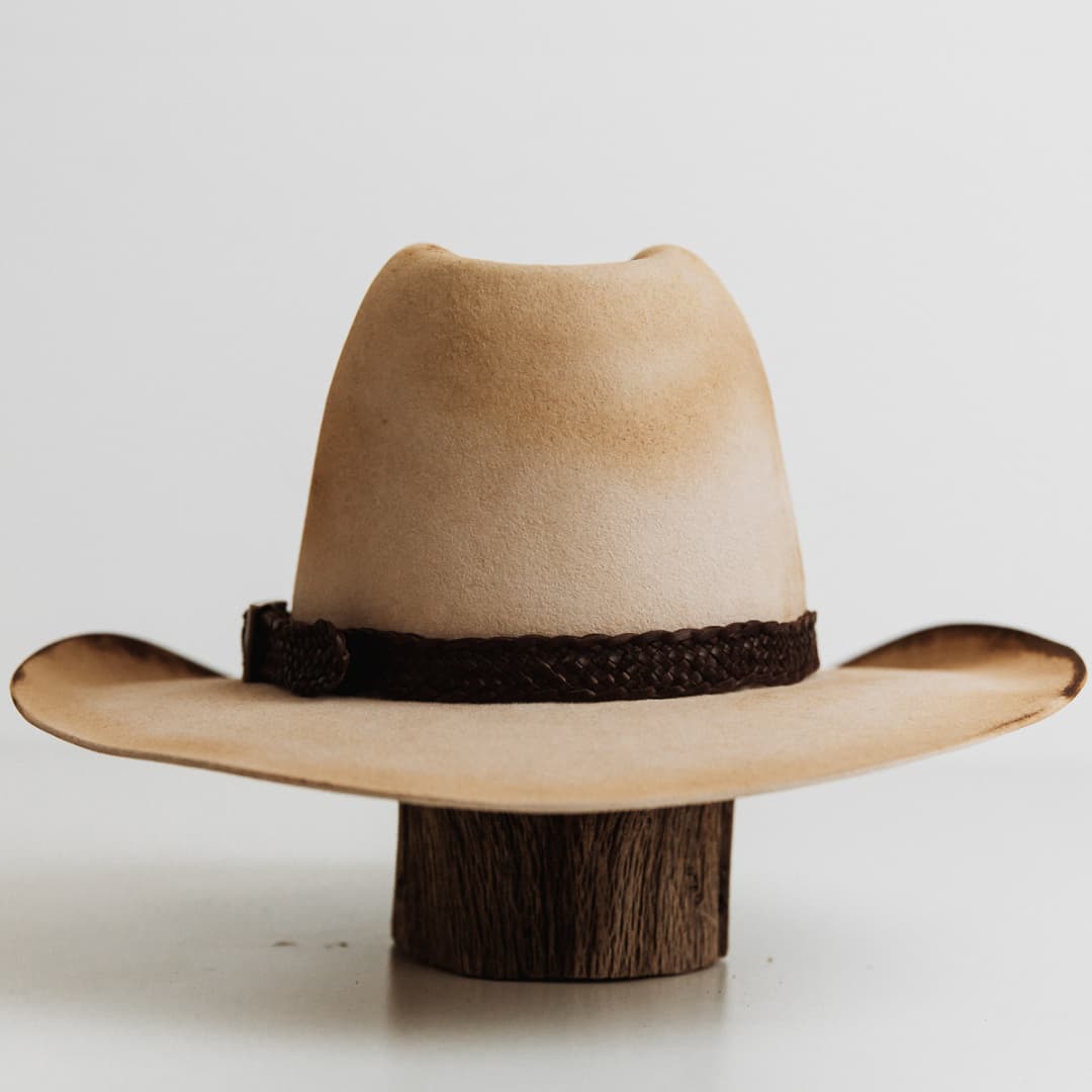 Back view of The Wheeler premium felt hat in distressed Beige with 12 strand leather hat band in Chocolate.