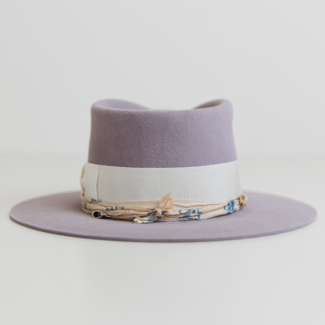 Back view of The Wisteria lilac felt hat by PHYLLi Designs with ivory grosgrain band.