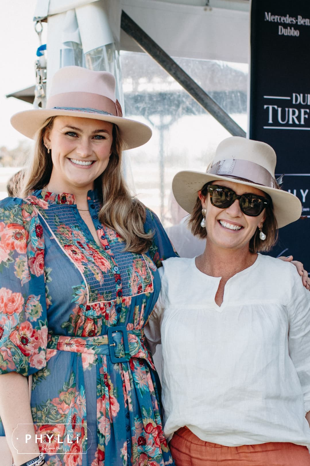 PHYLLi founder Laura Hall wearing the Tourmaline Baby Pink felt hat by PHYLLi Designs with rose quartz hat necklace at a race day event.