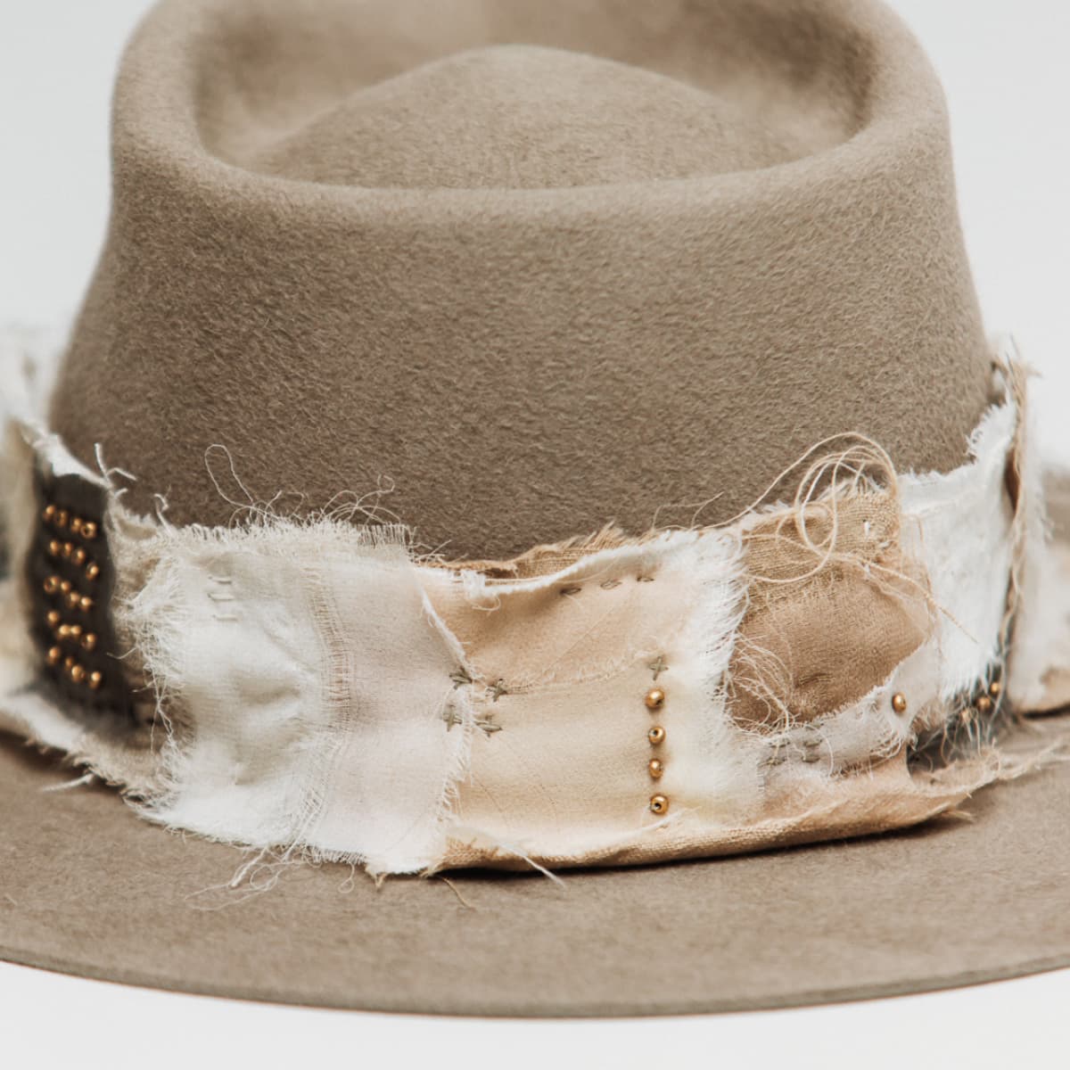 Close up detail of the Wabi Limited Edition felt hat showing layered linen, cotton, organza and georgette silk patch band.