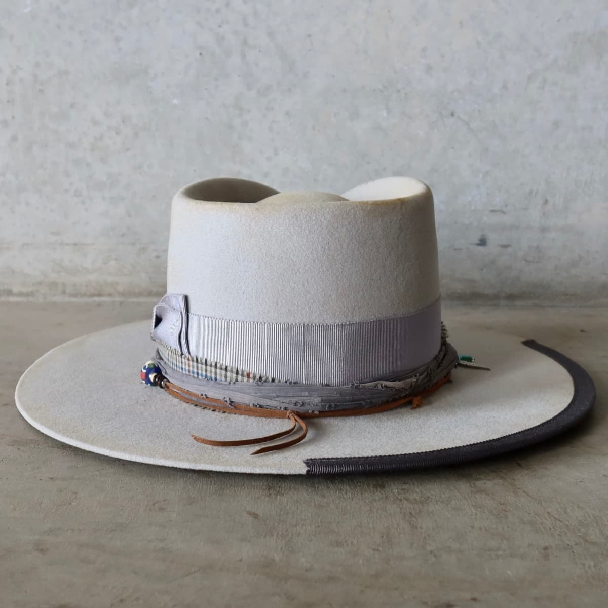Back view of the Dove felt hat Watson Limited Edition by PHYLLi Designs featuring Japanese grosgrain bow band and layered sari silk and cotton trims.