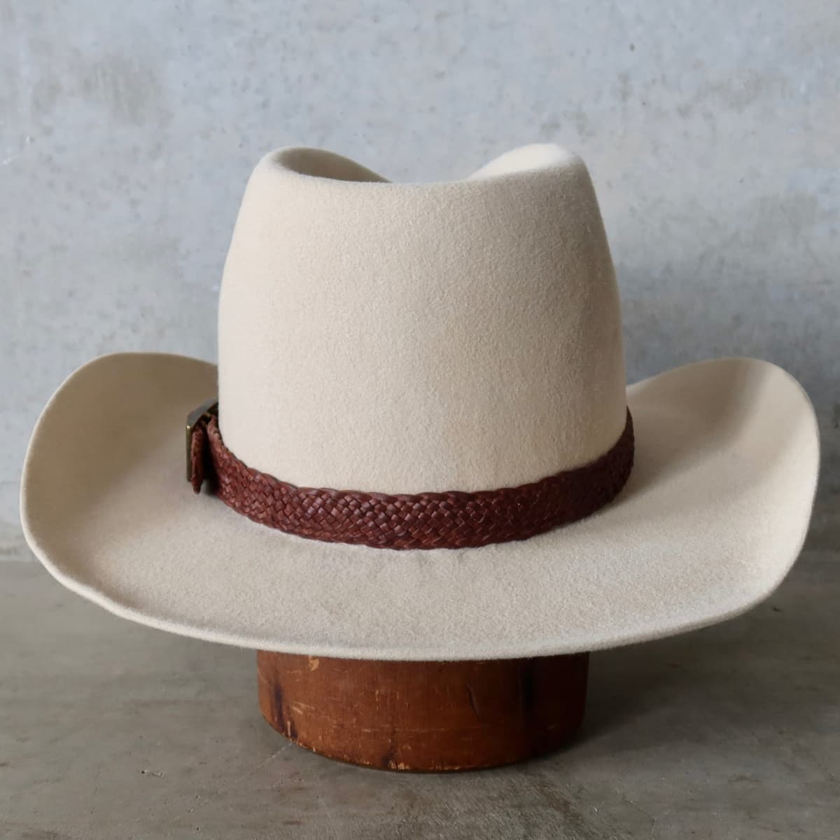 Back view of the beige cowboy hat Wheeler Beige by PHYLLi Designs featuring 12 strand chocolate leather hat band.