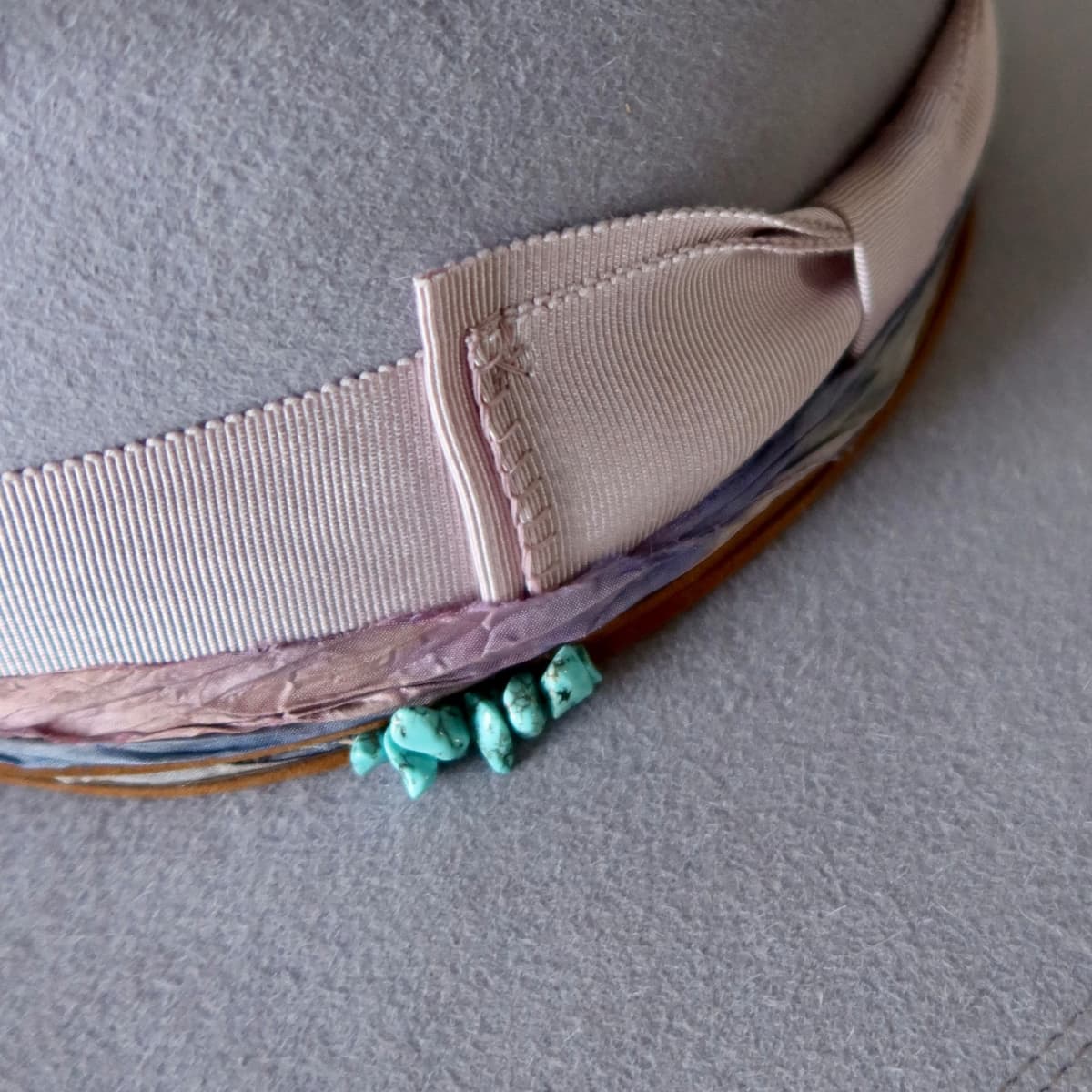Close up detail of the Wolseley felt hat showing lilac grosgrain double bow band with blanket stitch detailing.